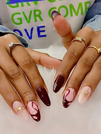 Because it's trending. This beautiful set combines a deep, rich red with soft pink accent nails featuring abstract art and a celestial starburst.