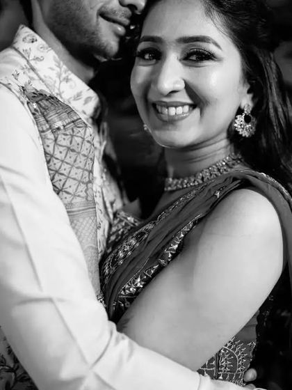 A candid and happy black and white portrait of the couple, their genuine smiles lighting up the frame.