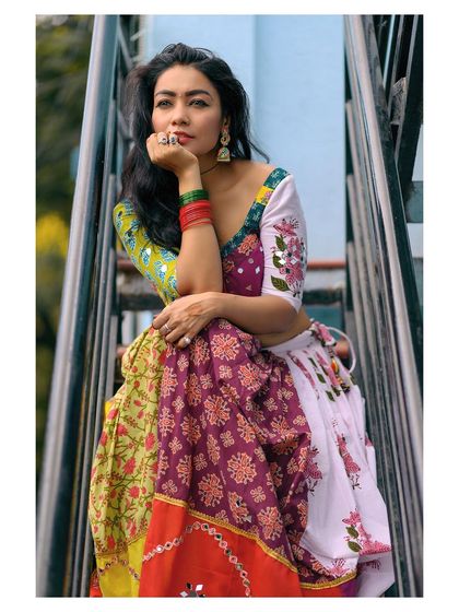 A seated pose on a staircase, which adds an urban, rustic element to this ethnic wear shoot.