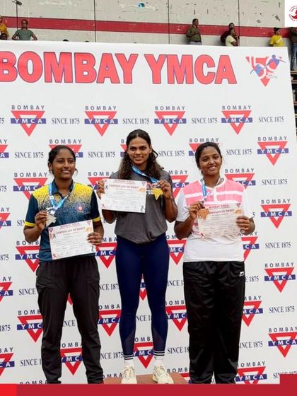 Our female athletes celebrating their medal wins on the podium at the 48th Bombay YMCA Open State Athletics Meet.