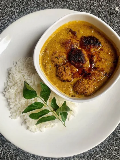 A comforting bowl of Pork Kaima Undey Curry. These are tender, handmade pork meatballs simmered in a rich, fragrant gravy made with coconut, poppy seeds, and traditional Coorgi spices.