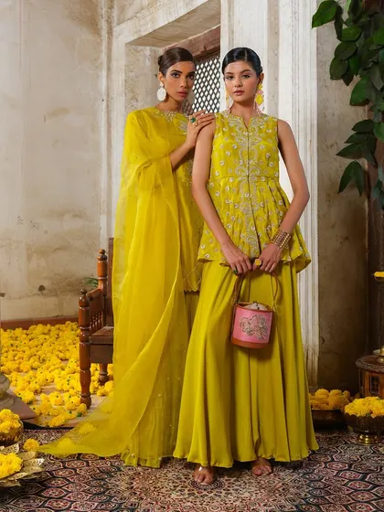 A vibrant yellow sharara set from the Jashn-de-Fleurs collection, perfect for a daytime celebration.