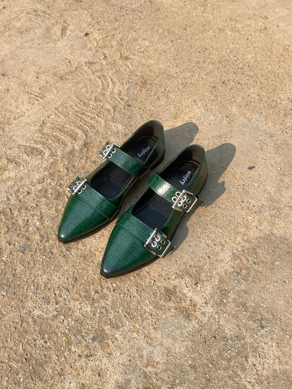 The buckled ballet flat in a deep forest green. This rich, jewel-toned color is a fantastic way to add a touch of understated color to your look, and the croc texture gives it an extra dimension of style.