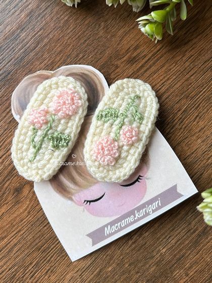 A close-up of our pink floral embroidered hairpins. These clips are soft, lightweight, and gentle on the hair, making them perfect for both adults and children.