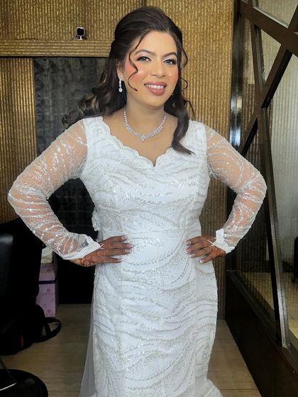 A full portrait of this sparkling bride. The soft waves in her hair and the shimmering eye makeup create a look of effortless glamour.