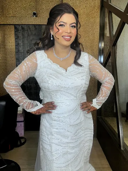 A full portrait of this sparkling bride. The soft waves in her hair and the shimmering eye makeup create a look of effortless glamour.