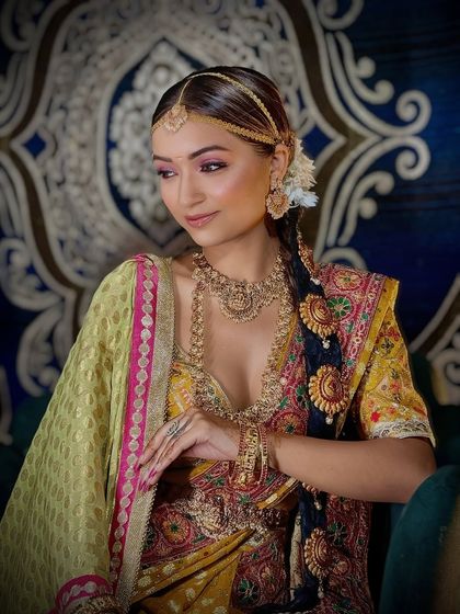 A side profile of the South Indian bridal look, highlighting the intricate hairstyle and jewelry.