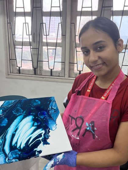A student proudly displays her beautiful blue and white fluid art creation during my workshop at VESCOA college. The patterns created by pouring paint are always unique and mesmerizing.