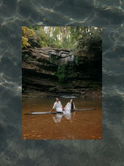 An artistic edit of the couple sitting on a log in the water, framed by a water texture. This creative approach turns a beautiful photo into a unique piece of art.