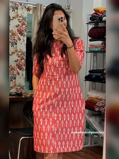 A mirror selfie showing the straight-fit Ikat dress in a lovely baby pink. It’s tailored for effortless style and everyday comfort.