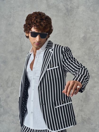 A confident pose in my black and white striped suit. This look is designed for the modern man who appreciates a blend of classic patterns and contemporary tailoring.