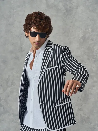 A full-body shot of our black and white striped suit, showcasing its modern silhouette and sharp lines.