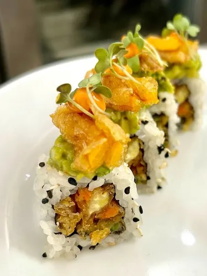 A close-up of our crispy tempura sushi rolls, showcasing the crunchy texture and fresh toppings. A perfect bite for any sushi lover.
