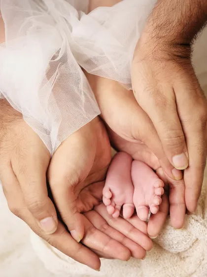Sometimes the most powerful photos are in the tiny details. I love capturing shots like this, with a newborn's perfect little feet held securely in their parents' hands. It’s a beautiful symbol of family and protection.