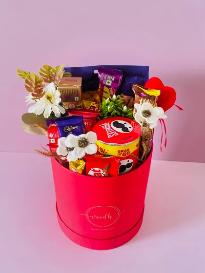 This large red round box is a chocolate lover's dream. I've filled it to the brim with a variety of chocolates, Pringles, and other snacks.