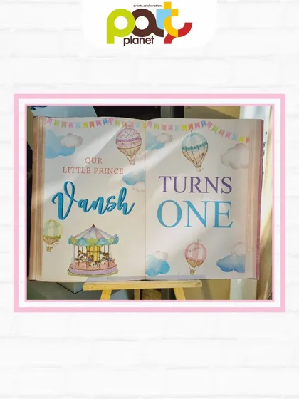 A charming storybook-style welcome sign for a first birthday, featuring a whimsical hot air balloon and carousel theme.