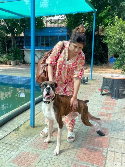 A proud pet parent with her Boxer after a successful and enjoyable swim session.