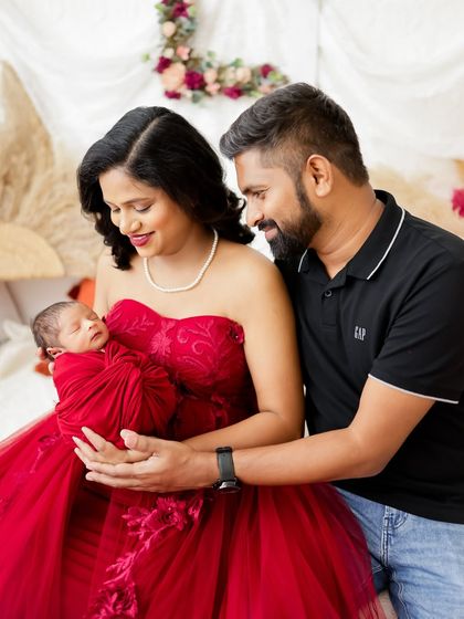 Another angle from a beautiful family session, showing the parents' adoring expressions as they look at their new baby.