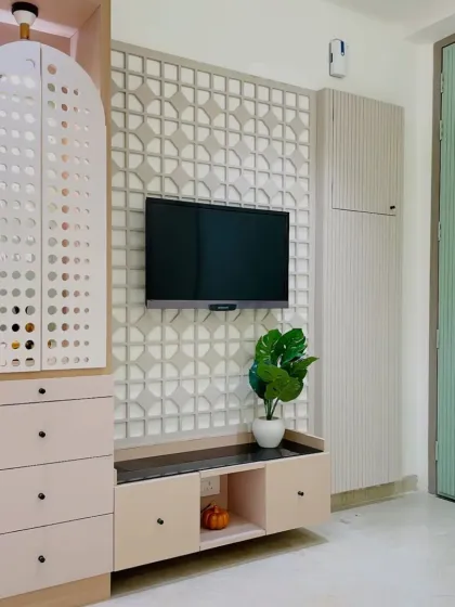 A modern TV unit that also incorporates a stylish pooja unit with a perforated door. This is a great example of our multi-functional and space-saving designs.