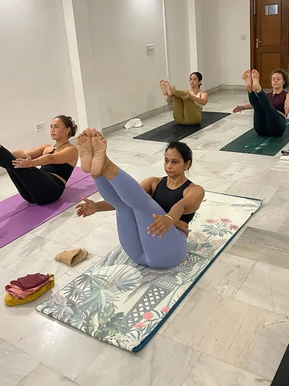 Another view of Navasana, showcasing the core engagement and focus required. We invite you to come flow, breathe, and heal with us.