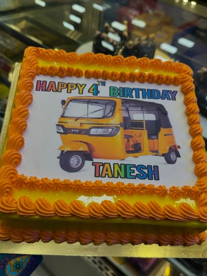 A fun photo cake featuring an auto-rickshaw for a 4th birthday. This shows that I can print any image you want to make the cake truly unique and personal.