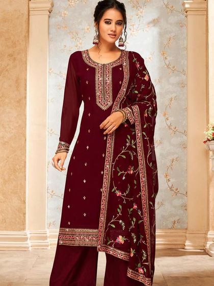 A rich brown salwar kameez with delicate floral embroidery. The georgette fabric and mirror work add a touch of elegance and shine.