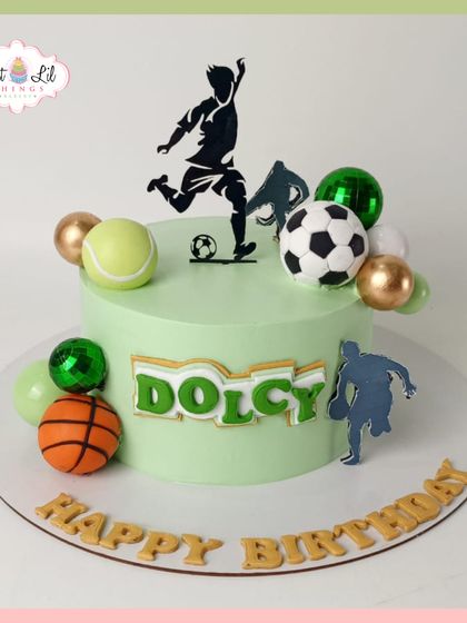 Game on! A sports-themed cake for Dolcy, featuring a soccer ball, basketball, and tennis ball for the all-around athlete.