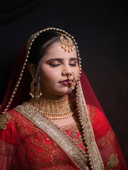 Another shot of the student's North Indian bridal look, showcasing the complete makeup with eyes closed.