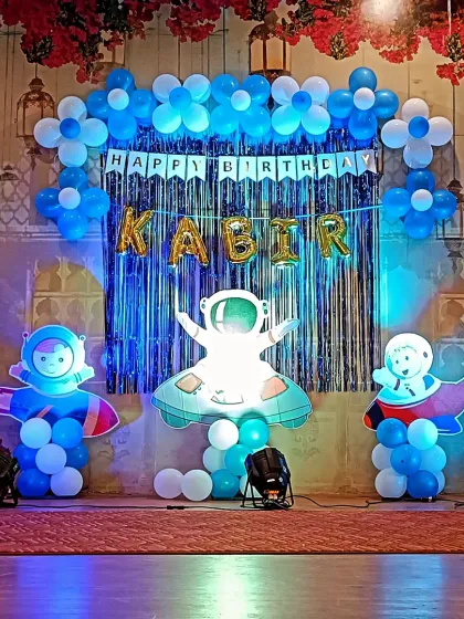 Another perspective of the cosmic celebration, showing the full spread of the balloon decor and the placement of the astronaut and rocket ship cutouts.