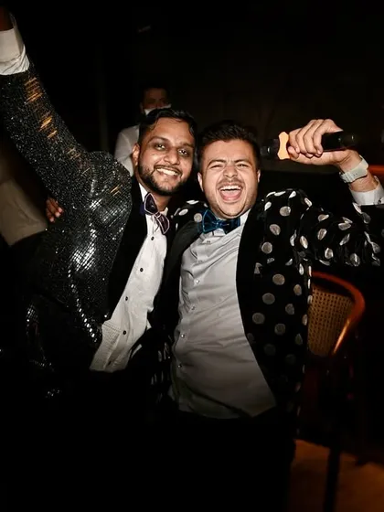 A candid moment with the groom at his cocktail party. I don't just host the event; I become a part of the celebration, sharing in the joy and laughter.