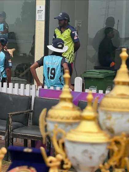 A view from behind the trophies, looking at the players in the pavilion. The goal is always in sight.