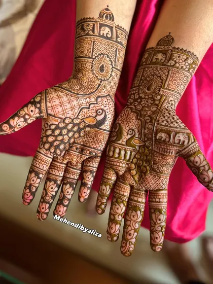 A gorgeous design featuring majestic peacocks and elephants, classic symbols of grace and royalty in Indian weddings. The lotus motifs on the fingers add a delicate touch.