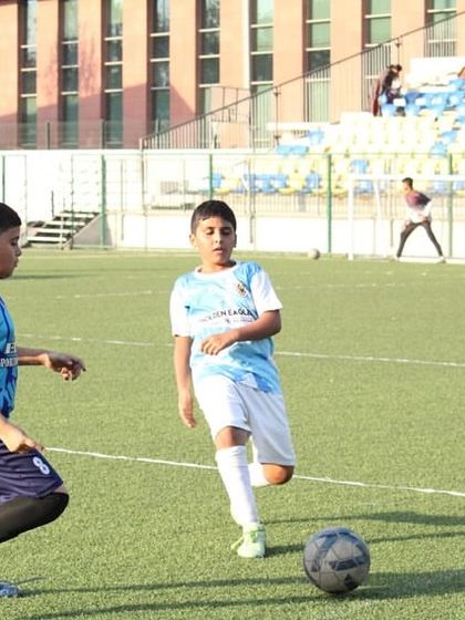 A player takes a shot on goal during a U12 match. We train our players to be decisive and confident in front of the goal.