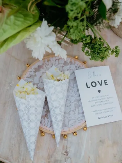 A small but meaningful detail. We placed custom notes and cones of petals on each seat, inviting guests to shower the couple with love and blessings.