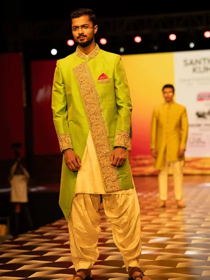 A vibrant ethnic look for Santhosh Kumar's design studio at Mysore Fashion Week. The bright green and gold required a regal and composed walk.