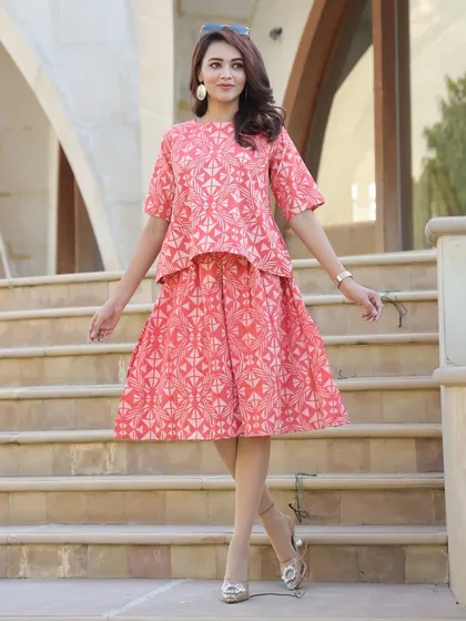 Another look at the coral pink geometric print set, styled for an elegant occasion.