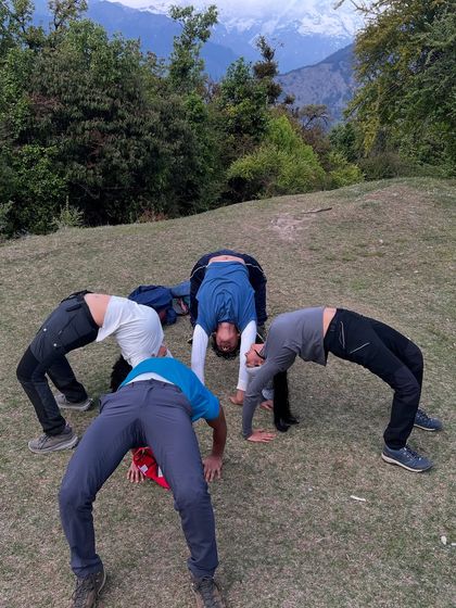 A playful moment exploring Chakrasana (Wheel Pose) together during a mountain trek. My group sessions are not just about serious practice but also about finding joy and connection through movement.
