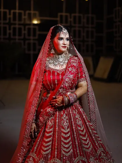 My bride Priya looking absolutely regal in her red embroidered lehenga. I gave her a classic makeup look with a bold red lip to match.