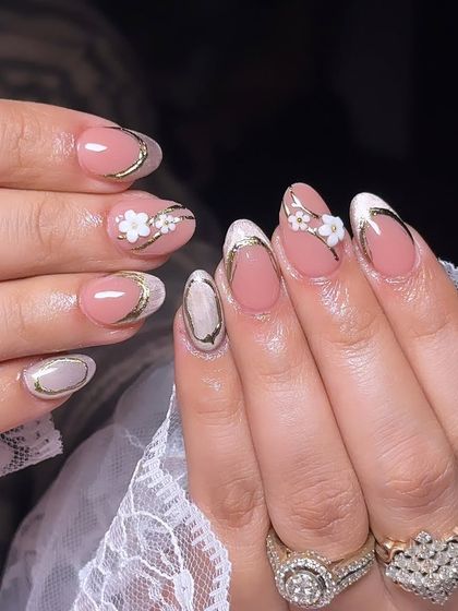 An elegant design with a pink base, gold chrome outlines, and delicate 3D white flowers.