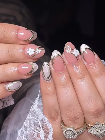 An elegant design with a pink base, gold chrome outlines, and delicate 3D white flowers.