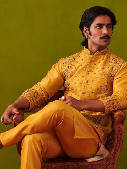 A seated pose in the yellow kurta set, exuding a relaxed yet regal charm. The Nazaakat collection is designed to make you feel like royalty in every setting.