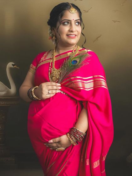 Holding a peacock feather, this mom-to-be looks absolutely radiant. The fine art editing style turns this traditional maternity portrait into a piece of art.