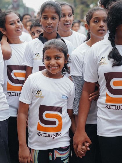 A young girl with a bright smile, happy to be part of the community walkathon.