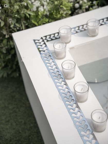 Simple, elegant details like these small candles lining a water feature add a touch of minimalist beauty and warm light.