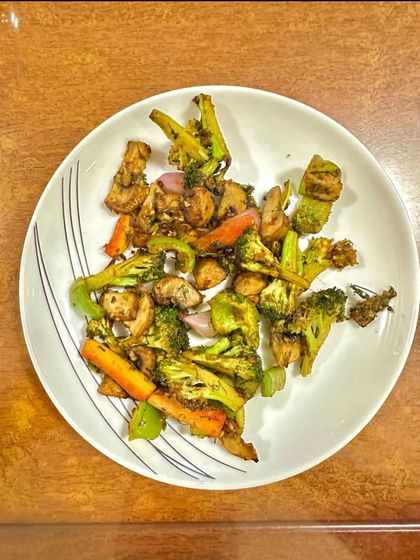 A plate of stir-fried broccoli, carrots, and other vegetables. This is a simple and effective way to get your daily dose of vitamins and fiber.