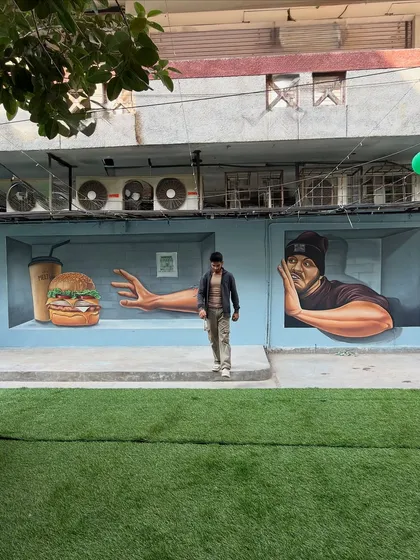 Another perspective of the full 3D mural at the cafe, showing how it occupies the length of the wall and creates a dynamic visual experience from different angles.