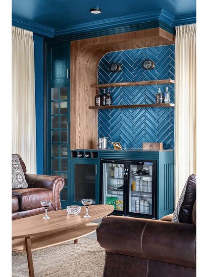 For this multifunctional bar and entertainment space, I chose a rich teal hue for the walls. The room receives ample natural light, so the deep color creates a cozy and inviting atmosphere without feeling dark.