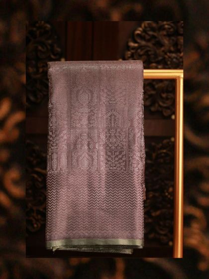 A sophisticated grey Kanjivaram with intricate silver zari work and geometric motifs.