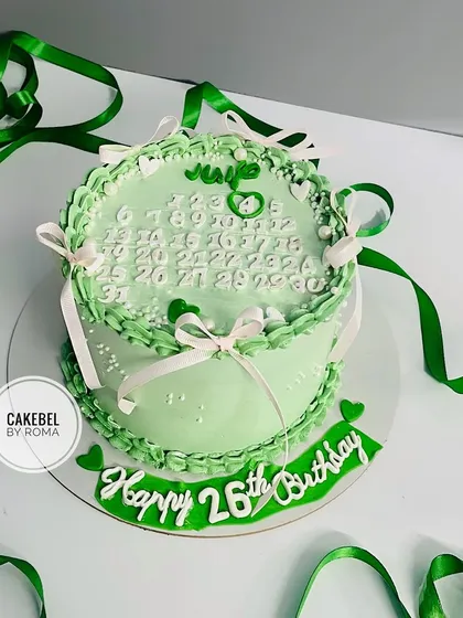 A lovely green vintage-style cake for a 26th birthday, featuring a calendar marking the special day.