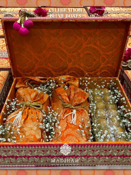 Another angle of the Celebration Bhaji Box, highlighting the delicate baby's breath flowers and silk potlis inside.